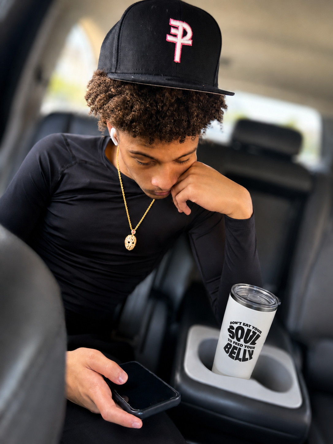 Model wearing Positive Energy Always headwear beside a Soul Belly tumbler